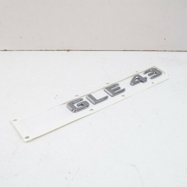 A1668176400 - NEW MB GLE W166 REAR TRUNK BOOTLID EMBLEM BADGE A1668176400 ORIGINAL