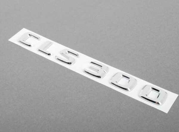 A2198171315 - NEW MERCEDES-BENZ CLS C219 REAR LID EMBLEM BADGE A2198171315 ORIGINAL